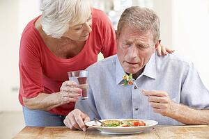 Senior woman looking after sick husband
