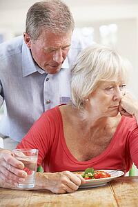 Senior man looking after sick wife