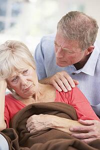 Senior man looking after sick wife