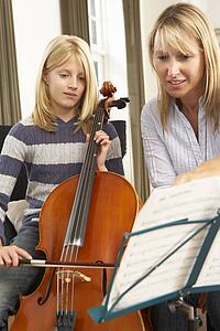 Girl playing cello in music lesson