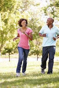 Young couple running in park