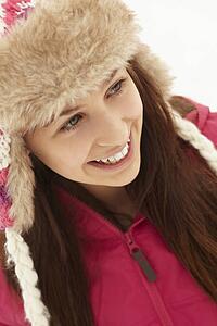 Portrait Of Teenage Girl In Snow Wearing Fur Hat
