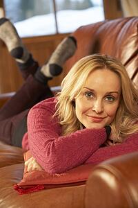 Middle Aged Woman Lying On Sofa