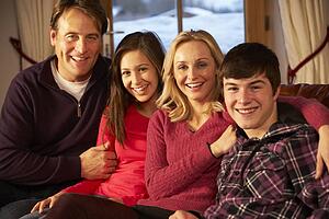 Portrait Of Family Relaxing On Sofa Together