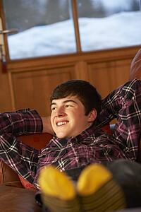 Teenage Boy Relaxing On Sofa