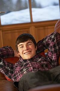 Teenage Boy Relaxing On Sofa