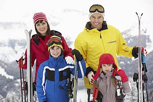 Family On Ski Holiday In Mountains