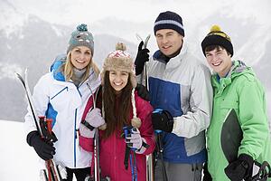 Family On Ski Holiday In Mountains