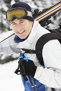 Middle Aged Man On Ski Holiday In Mountains