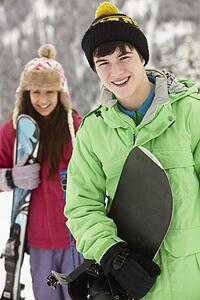 Two Teenagers On Ski Holiday In Mountains