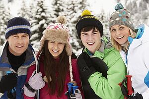 Family On Ski Holiday In Mountains