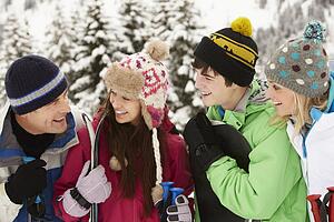 Family On Ski Holiday In Mountains