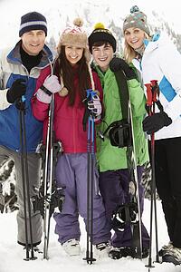Family On Ski Holiday In Mountains