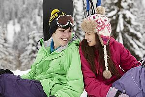 Two Teenagers On Ski Holiday In Mountains