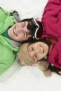 Overhead View Of Two Teenagers On Ski Holiday In Mountains
