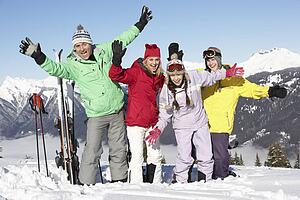 Teenage Family On Ski Holiday In Mountains