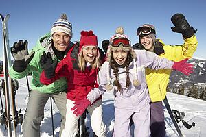 Teenage Family On Ski Holiday In Mountains