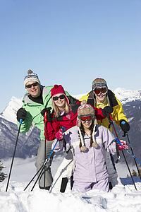 Teenage Family On Ski Holiday In Mountains