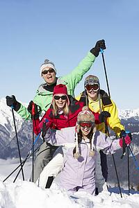 Teenage Family On Ski Holiday In Mountains