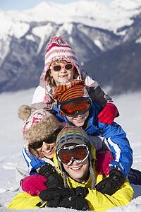 Group Of Children Having Fun On Ski Holiday In Mountains