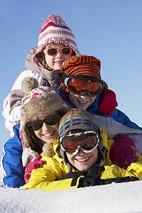 Group Of Children Having Fun On Ski Holiday In Mountains
