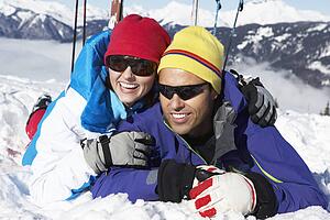 Couple Having Fun On Ski Holiday In Mountains