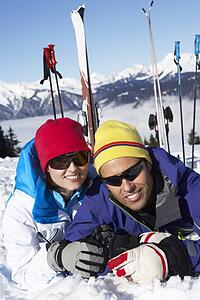 Couple Having Fun On Ski Holiday In Mountains