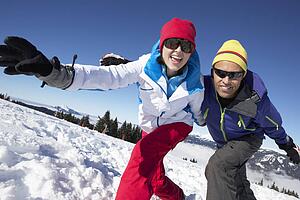 Couple Having Fun On Ski Holiday In Mountains