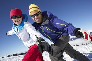 Couple Having Fun On Ski Holiday In Mountains