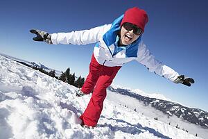 Woman Having Fun On Ski Holiday In Mountains