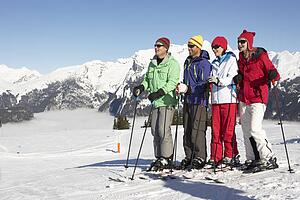 Group Of Middle Aged Couples On Ski Holiday In Mountains