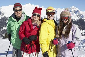Teenage Family On Ski Holiday In Mountains