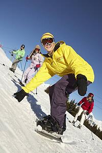 Teenage Family On Ski Holiday In Mountains