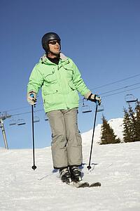 Man On Ski Holiday In Mountains