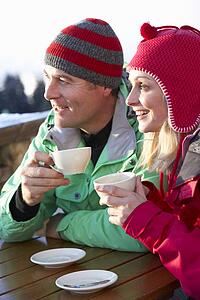 Couple Enjoying Hot Drink In CafÃ© At Ski Resort