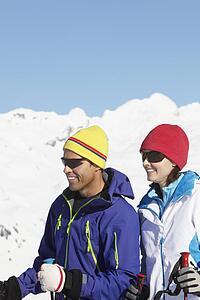 Couple Having Fun On Ski Holiday In Mountains
