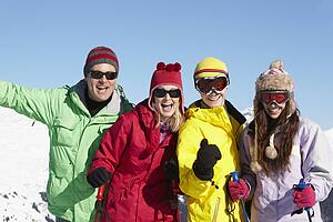 Teenage Family On Ski Holiday In Mountains