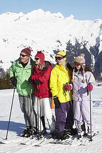 Teenage Family On Ski Holiday In Mountains