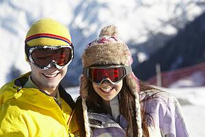 Two Teenagers On Ski Holiday In Mountains