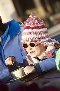 Young Girl Enjoying Hot Drink In CafÃ© At Ski Resort