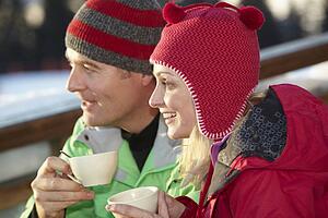 Couple Enjoying Hot Drink In CafÃ© At Ski Resort