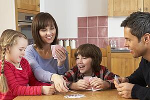 Family Playing Cards In Kitchen