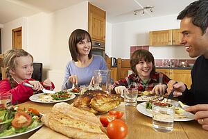 Family Eating Lunch Together In Kitchen