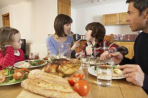 Family Having Argument Whilst Eating Lunch Together In Kitchen