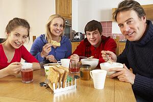 Family Eating Breakfast Together In Kitchen