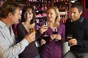 Group Of Friends Enjoying Drink Together In Bar