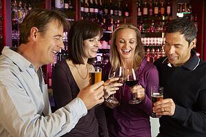 Group Of Friends Enjoying Drink Together In Bar