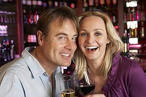 Couple Enjoying Drink Together In Bar