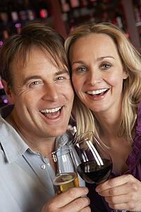 Couple Enjoying Drink Together In Bar