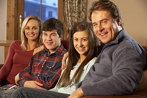 Portrait Of Family Relaxing On Sofa Together